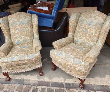 A pair of wing armchairs.