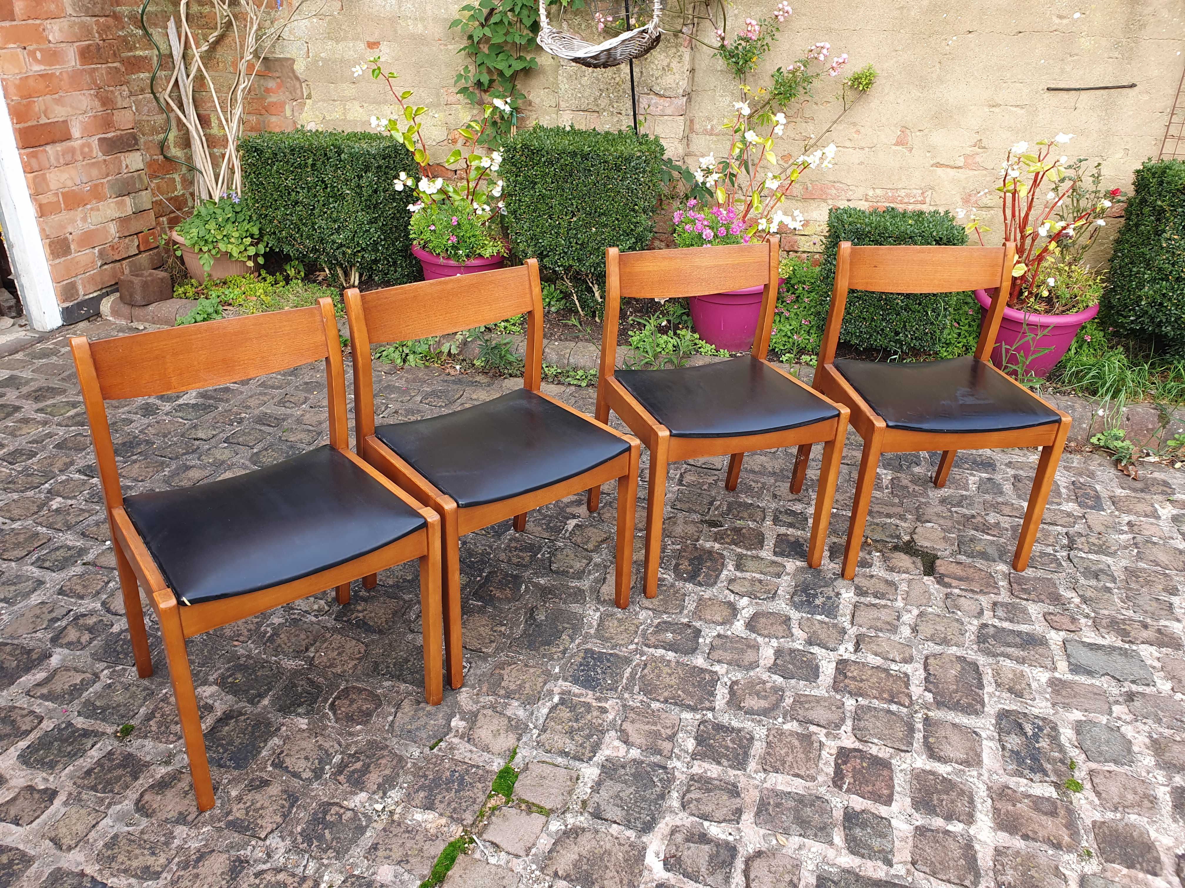 Four 60's teak dining chairs.